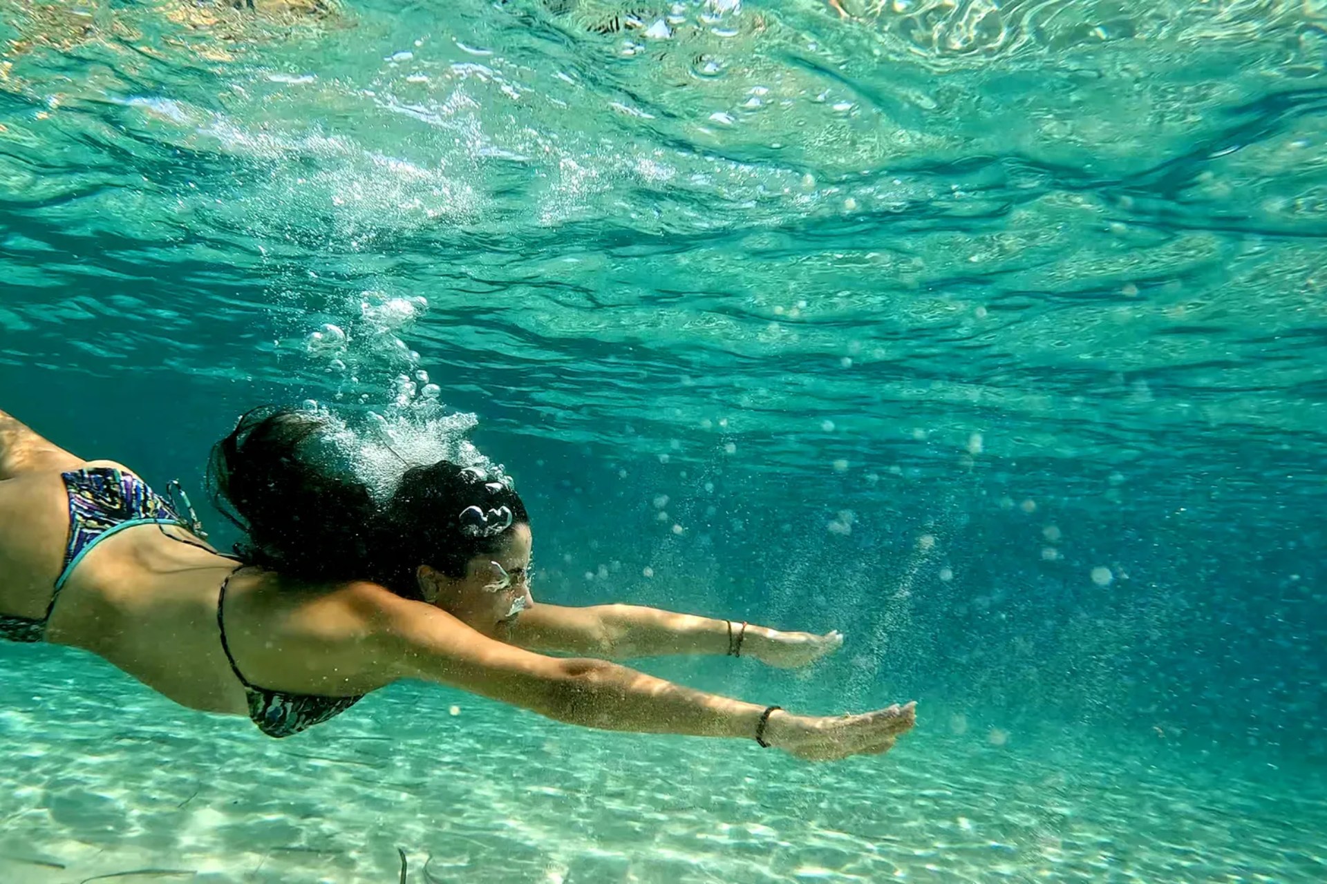 Girl underwater, on one of Keytours' island tours from Athens.